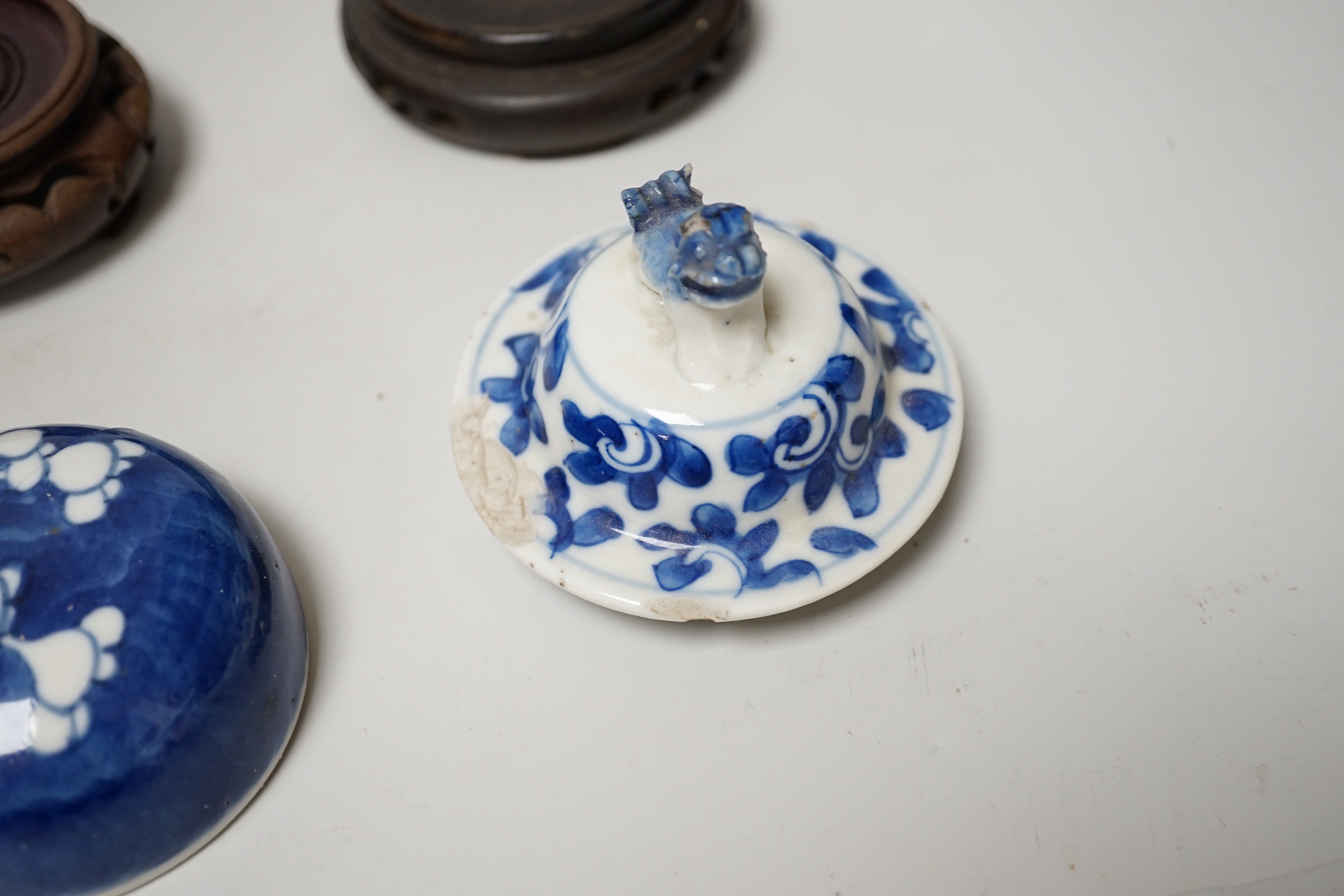 A group of Chinese wooden stands and ceramic lids